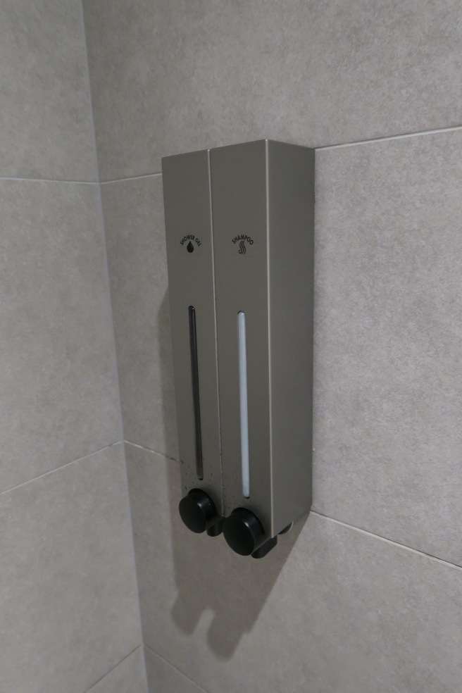 a soap dispenser on a wall