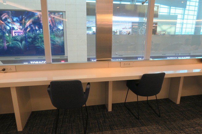 a table with chairs in front of a window