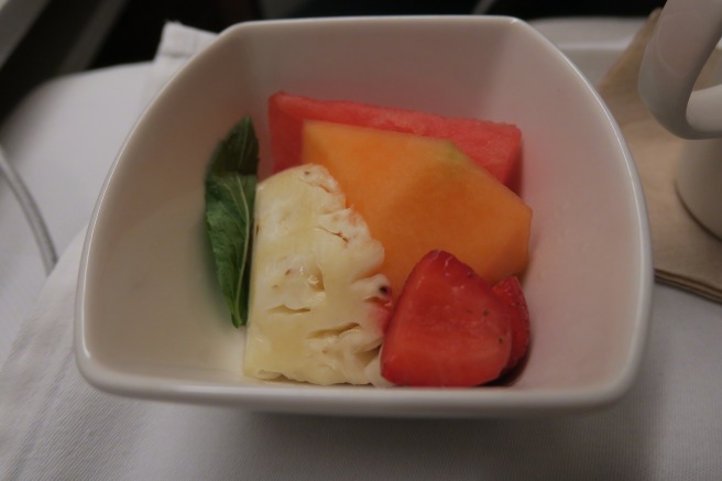 a bowl of fruit in a white bowl