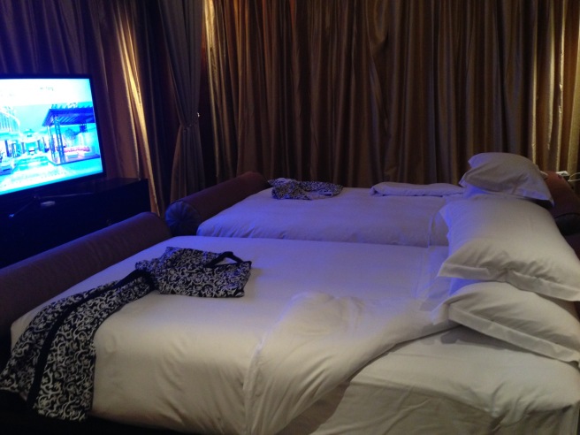 a room with a television and beds