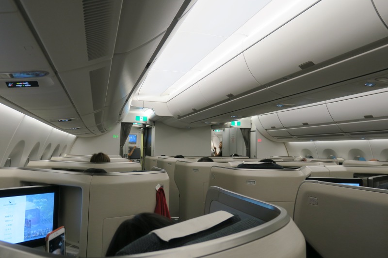 a plane with seats and a few people