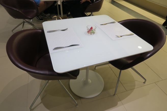 a table with chairs and a bowl of food on it