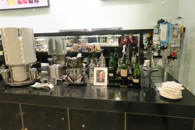 a counter with bottles and glasses on it