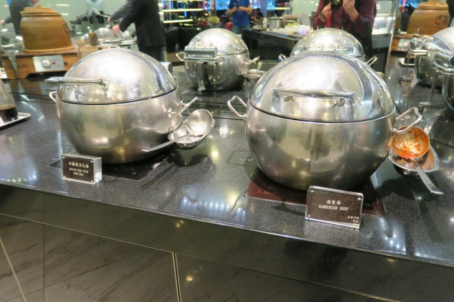 a group of silver pots on a counter