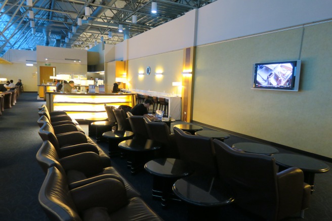 a lounge area with a bar and chairs