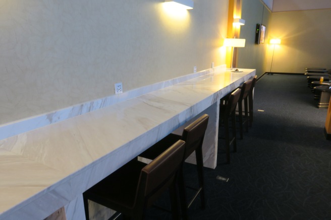 a long marble counter with chairs