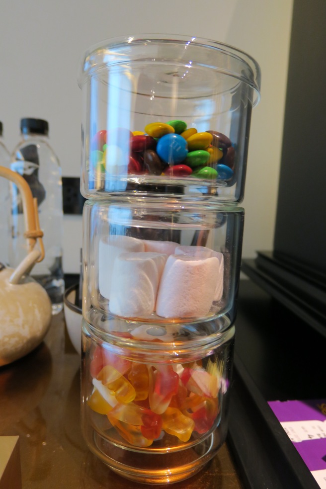 a stack of glass containers with candy inside