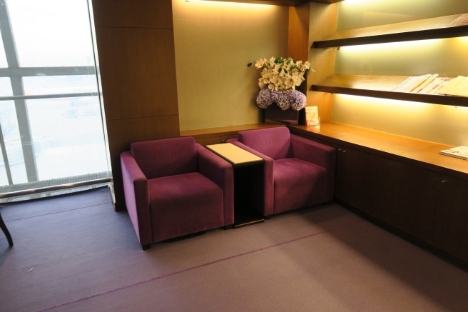 a room with purple chairs and a table