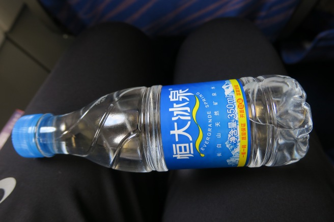 a bottle of water on a person's lap