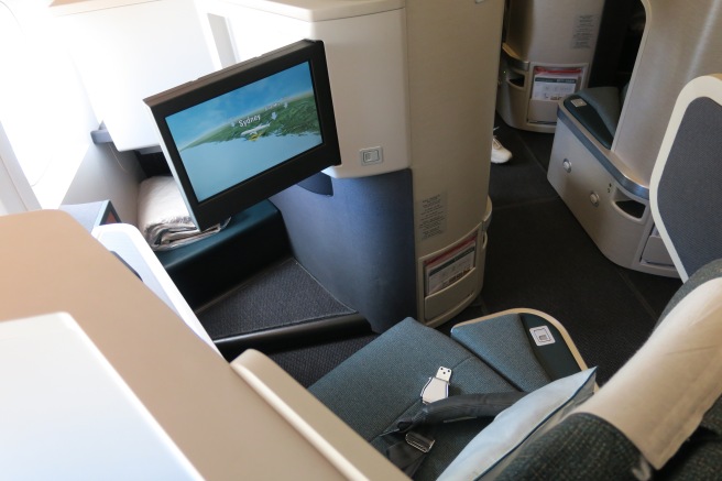 a monitor on a seat in an airplane