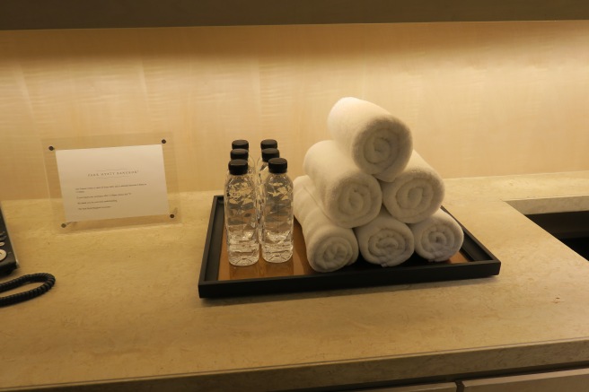 a tray with towels and water bottles on it