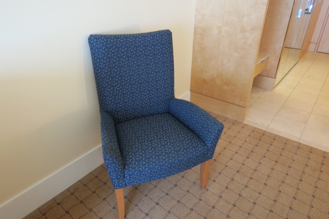 a blue chair in a room