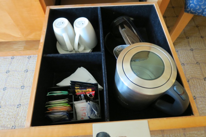a tray with a tea pot and teacups