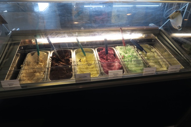 a trays of ice cream in a glass case