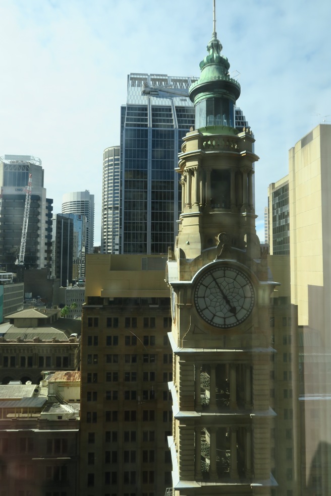 a clock tower with a tower in the background