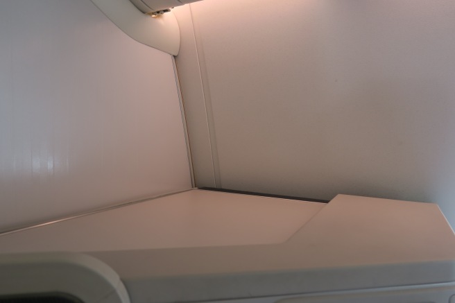 a white shelf in an airplane