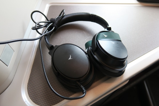 a pair of black headphones on a white surface