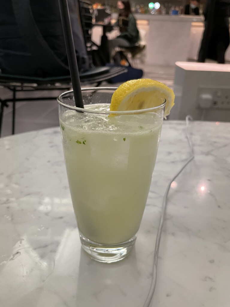 a glass of lemonade with a straw