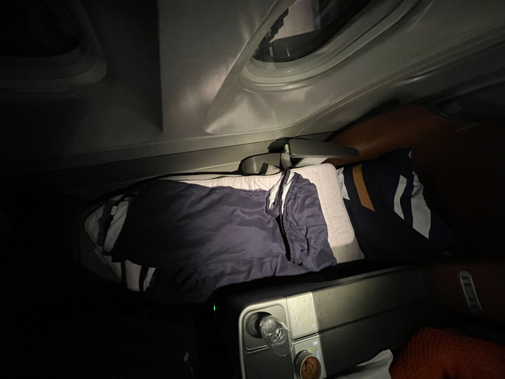 a bed and pillows in a plane