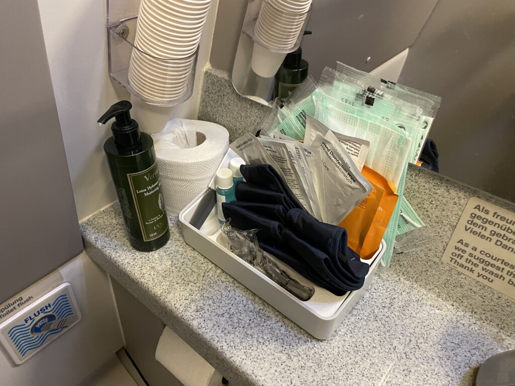 a bathroom counter with a container of items