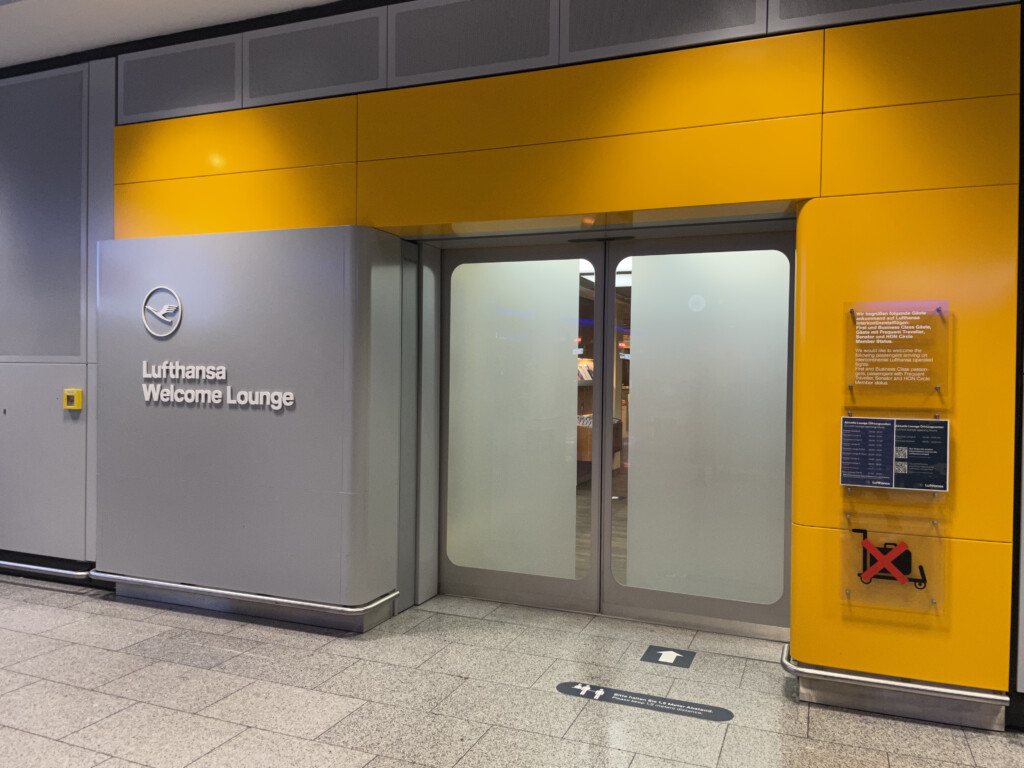 a yellow and grey building with glass doors
