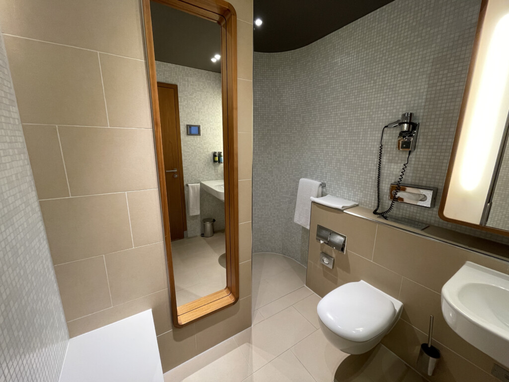 a bathroom with a mirror and toilet