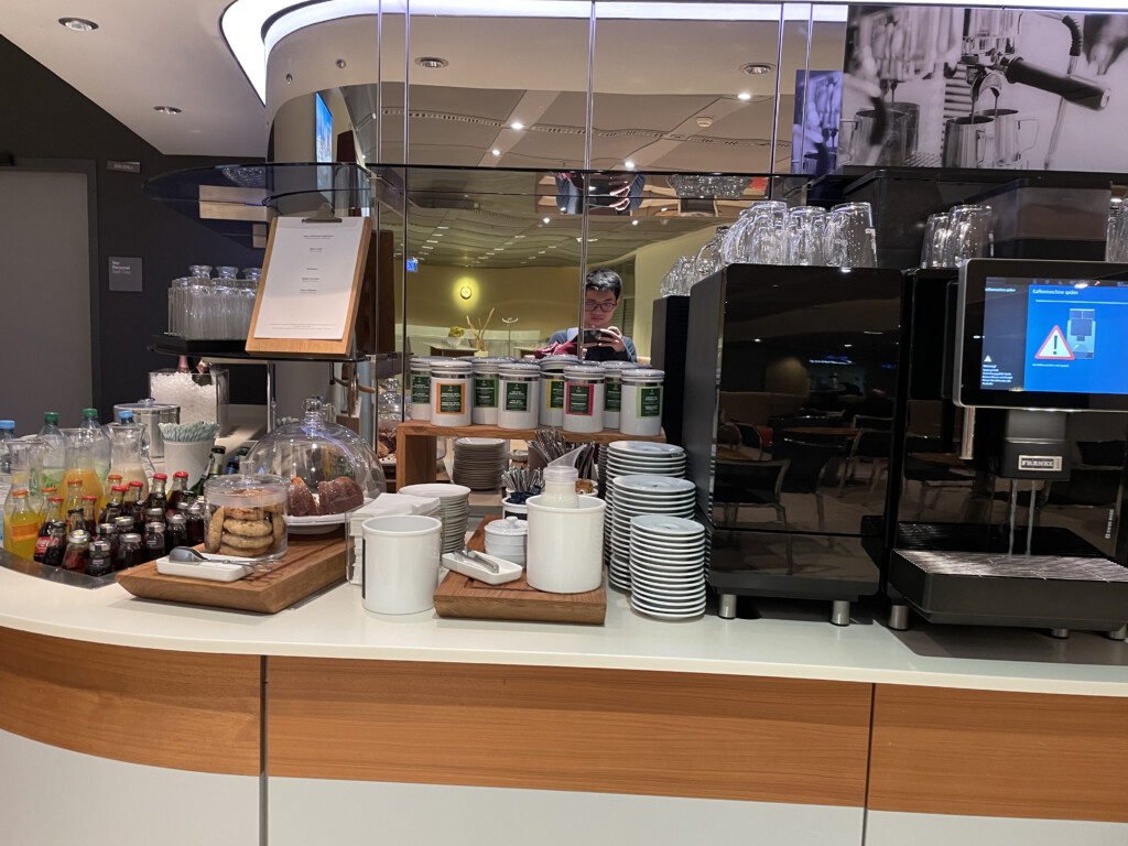 a counter with a variety of coffee machines and cups