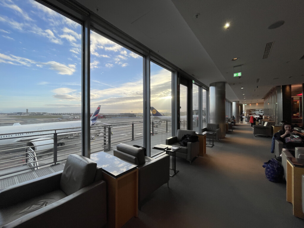 a large window with a view of an airplane and a runway