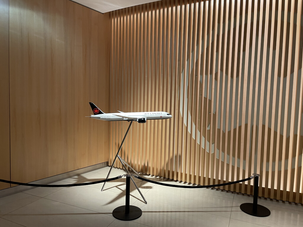 a model airplane on a stand in front of a wall