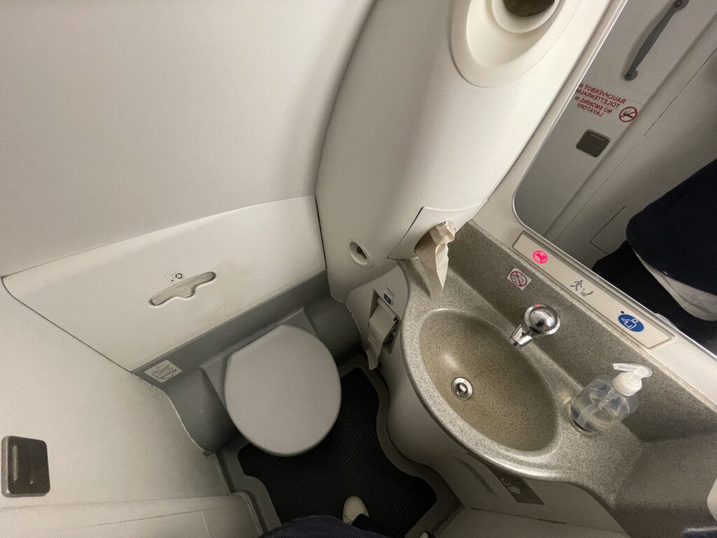 a toilet and sink in an airplane