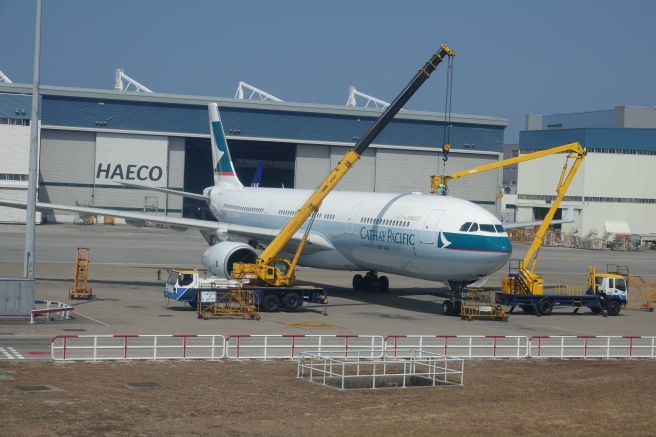 a large airplane being loaded with machinery