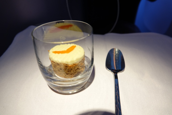 a small dessert in a glass with a spoon