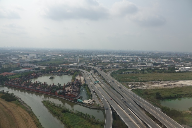 a highway with a river and buildings