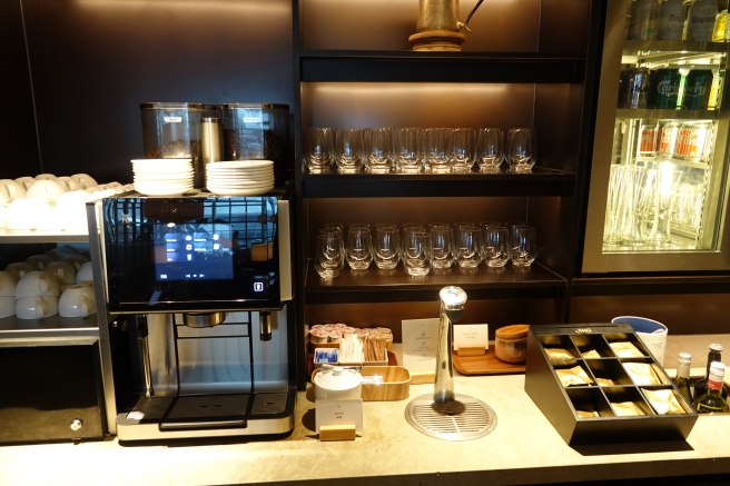 a coffee machine and glasses on a shelf