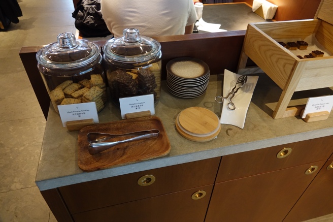 a counter with a few jars of cookies and plates