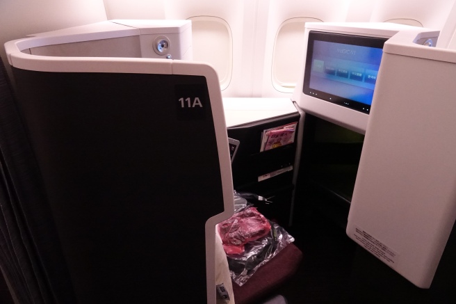 a screen and computer in an airplane