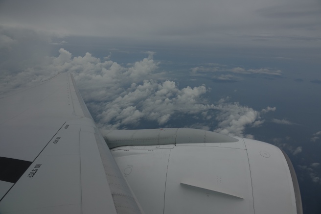 an airplane wing and clouds