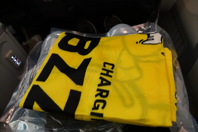 a yellow shirt with black text on it