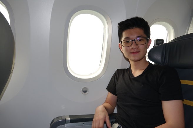a man sitting in a chair in an airplane