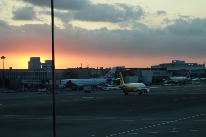 an airport with airplanes in the foreground
