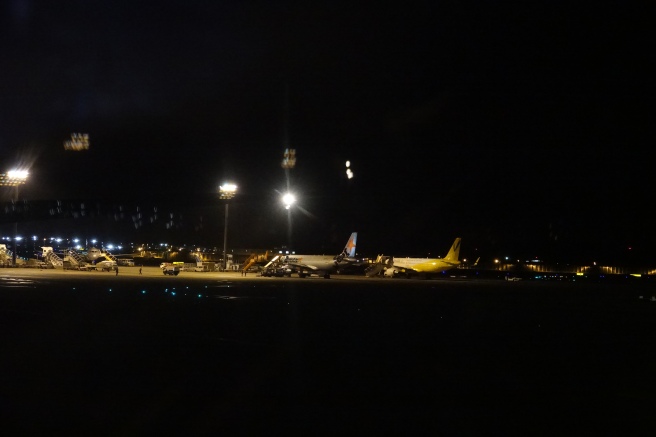 airplanes at night at an airport