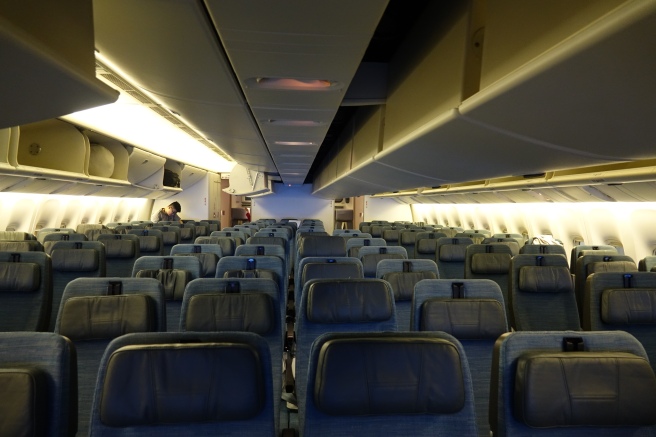 an airplane with seats and a person standing in the back