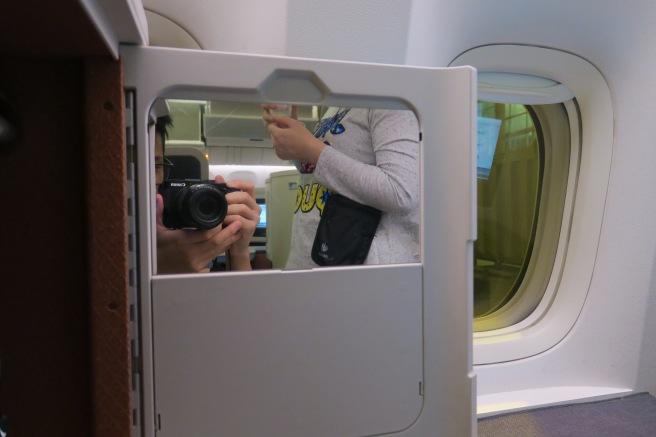 a person taking a picture of a person in an airplane