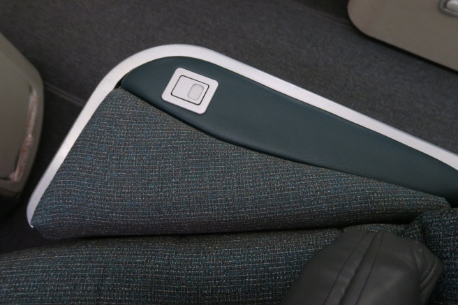 a seat armrest with a button on it