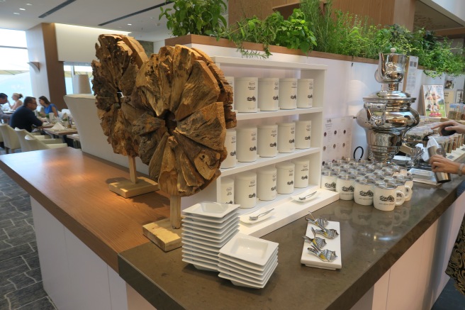 a counter with white cups and plates