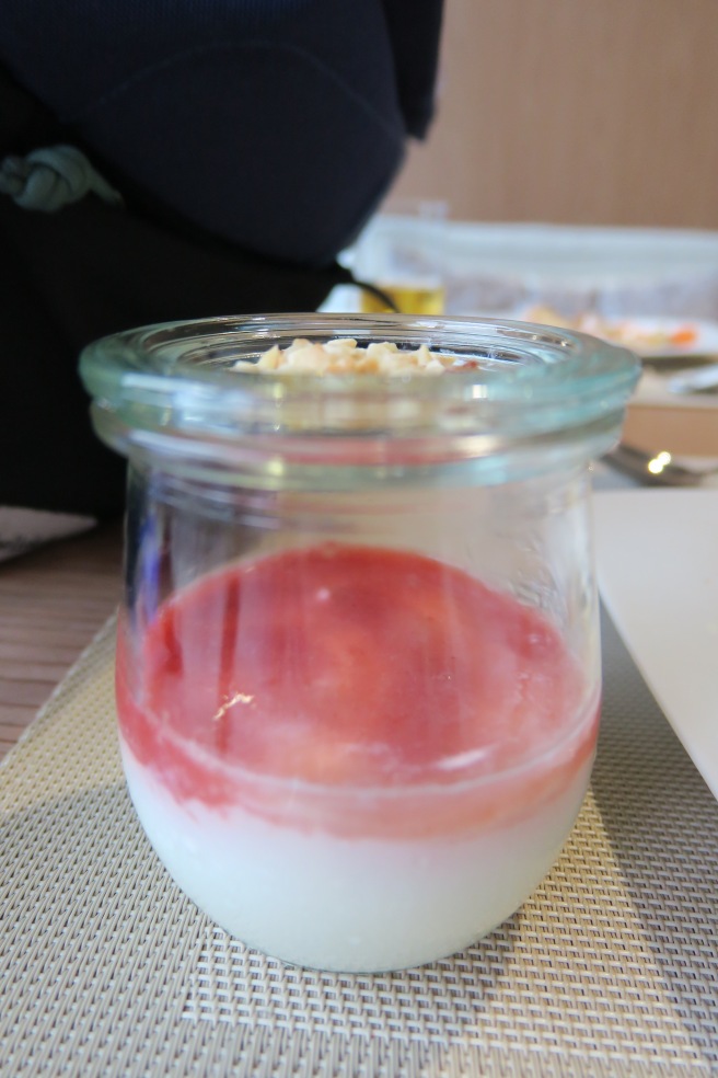 a glass jar with a red and white liquid in it