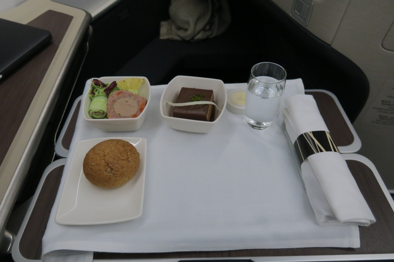 a tray with food and a glass of water on it