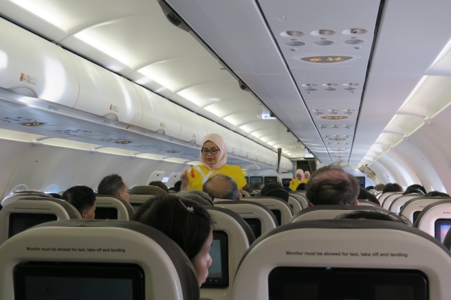 a woman standing in an airplane