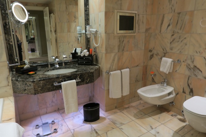 a bathroom with marble tiles and a sink