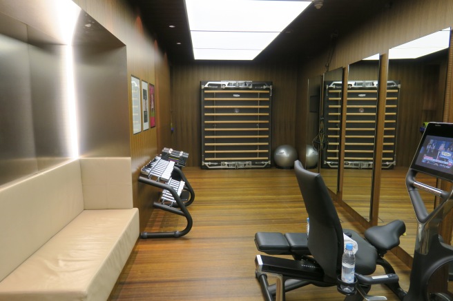 a room with a mirror and exercise equipment